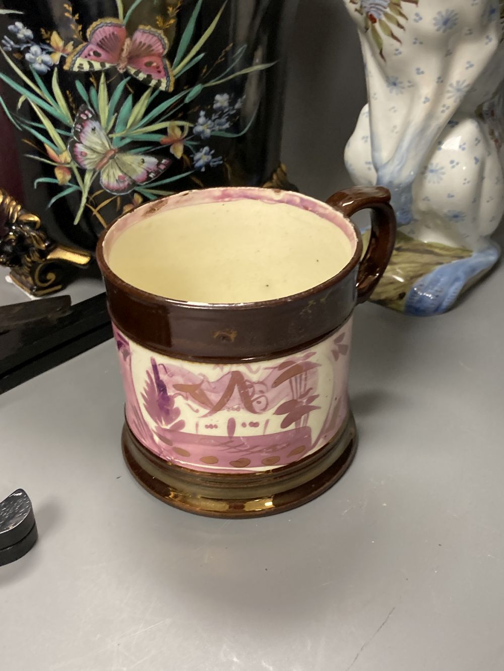 An opaline glass jug, an Edwardian jardiniere, a lustre mug and a novely whippet jug, 29cm